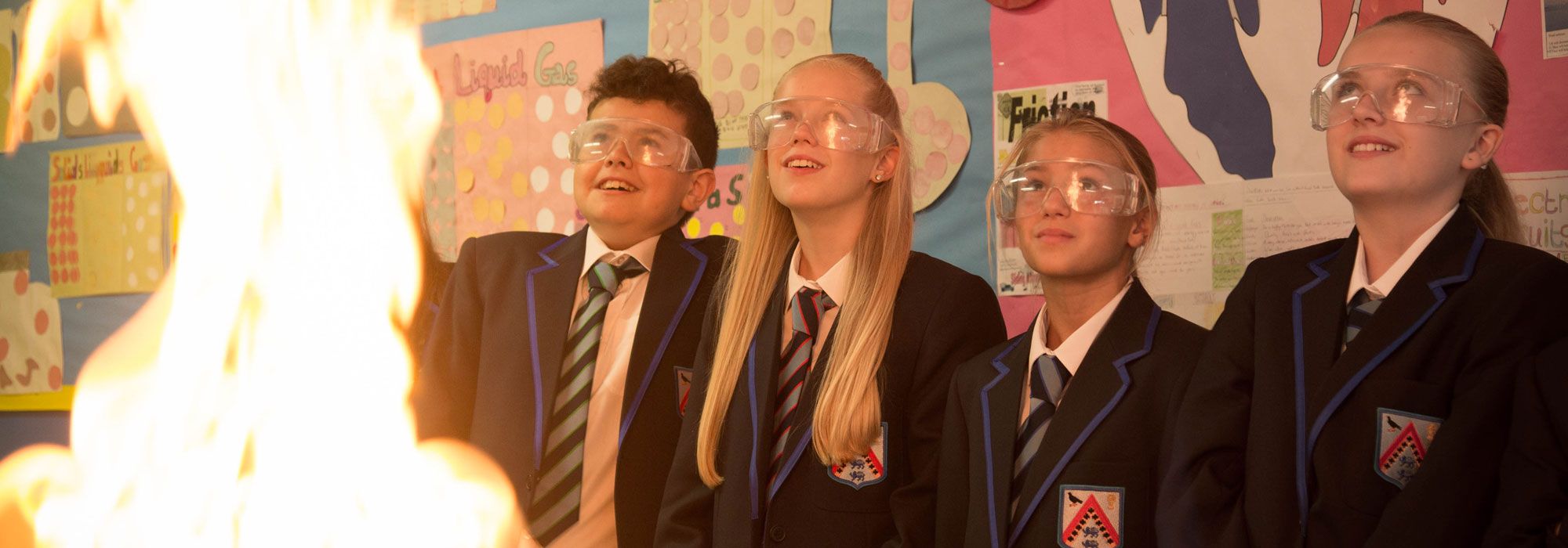 Science class with pupils watching flammable chemicals